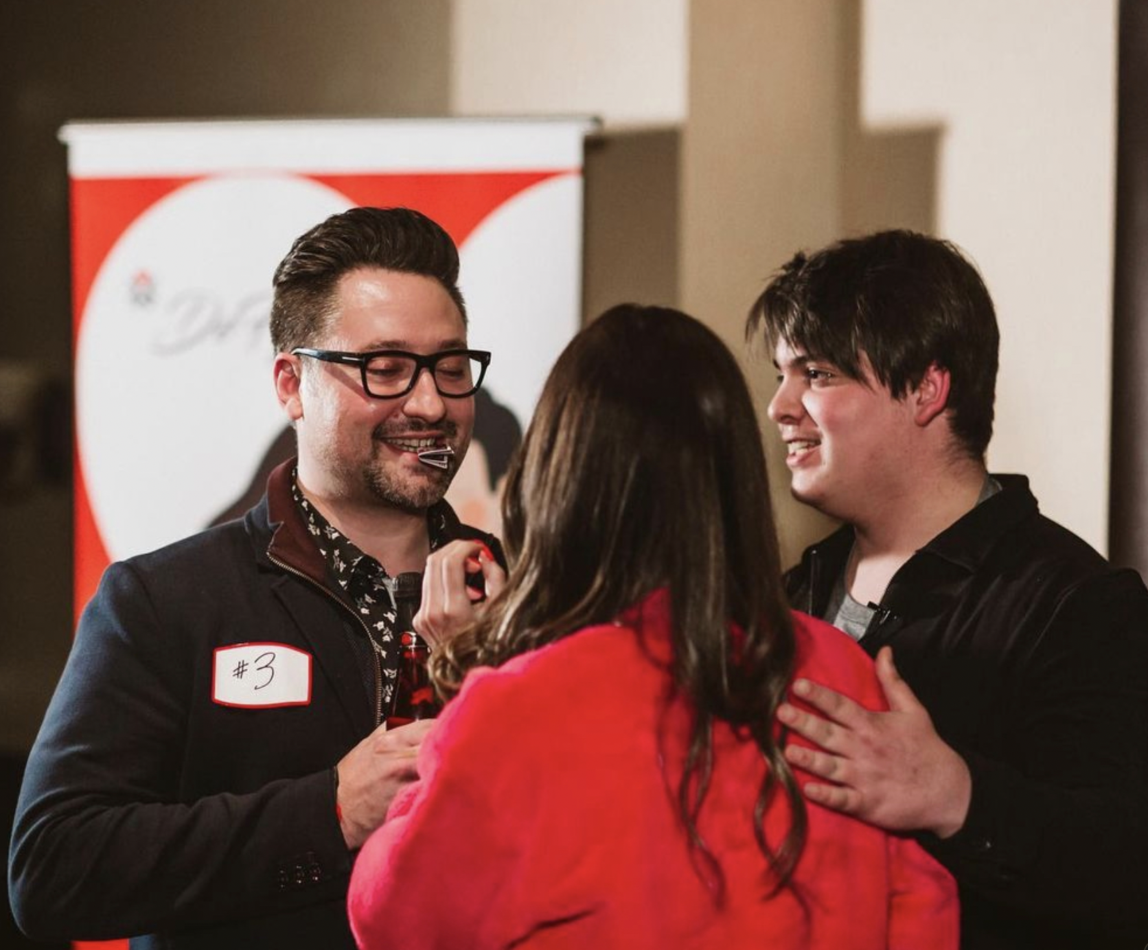 Marko sharing a magic trick with an audience at an event