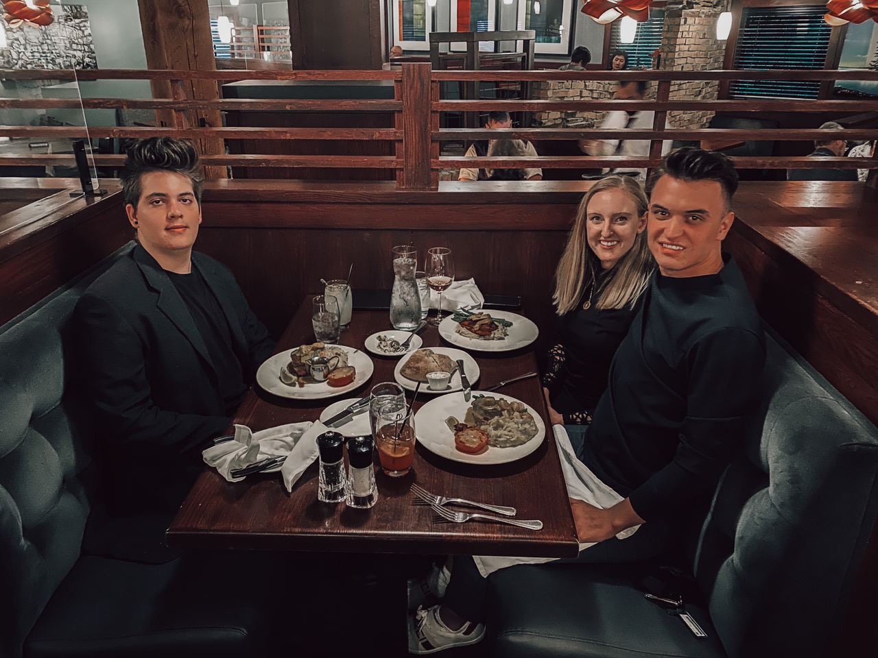 Marko sitting at dinner with his mentor and a guest